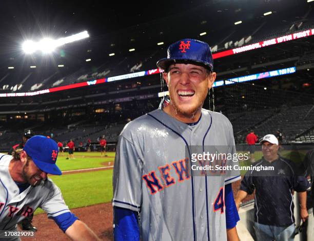 Zack Wheeler of the New York Mets smiles after being doused with a beer shower after game two of a doubleheader against the Atlanta Braves at Turner...