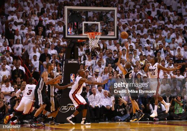 Tony Parker of the San Antonio Spurs makes a basket over Mario Chalmers of the Miami Heat in the fourth quarter during Game Six of the 2013 NBA...