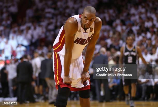 Chris Bosh of the Miami Heat reacts late in the fourth quarter while taking on the San Antonio Spurs during Game Six of the 2013 NBA Finals at...