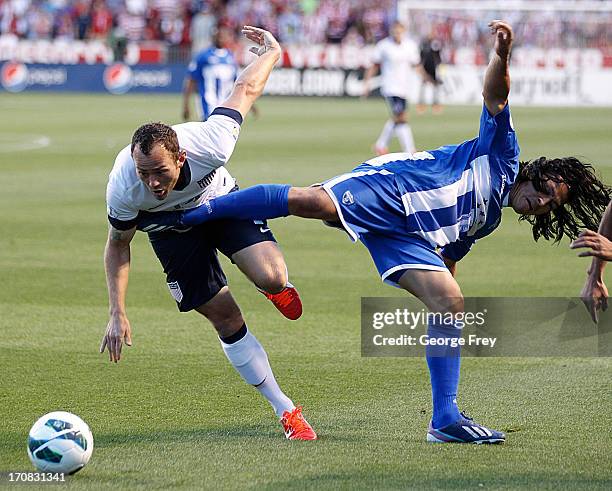 Brad Davis of the United States is kicked by Roger Espinoza of Honduras during the second half of a World Cup qualifying match on June 18, 2013 at...