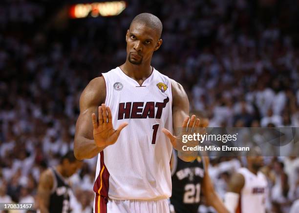 Chris Bosh of the Miami Heat reacts in overtime against the San Antonio Spurs during Game Six of the 2013 NBA Finals at AmericanAirlines Arena on...