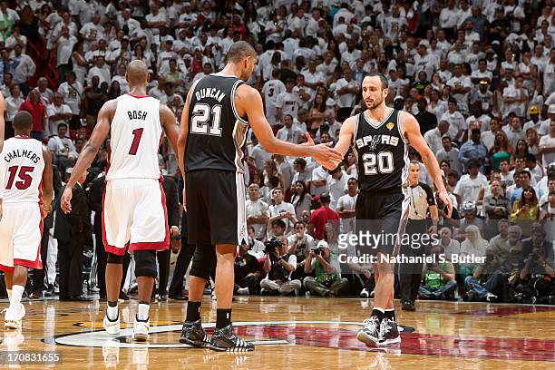 Teammates Tim Duncan and Manu Ginobili of the San Antonio Spurs high-five while playing against the Miami Heat in Game Six of the 2013 NBA Finals on...