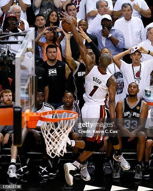 Chris Bosh of the Miami Heat blocks the last second three-point attempt by Danny Green of the San Antonio Spurs as the Heat defeat the Spurs 103-100...
