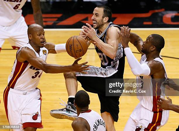 Manu Ginobili of the San Antonio Spurs loses the ball as he drives between Ray Allen and Dwyane Wade of the Miami Heat in overtime during Game Six of...