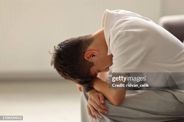teenager boy under stress - hand in hair stock pictures, royalty-free photos & images