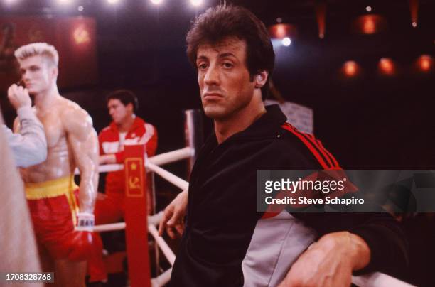 American actor and film director Sylvester Stallone as he leans against the ropes of a boxing ring on the set of the film 'Rocky IV,' Los Angeles,...