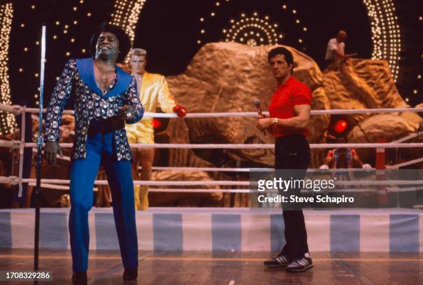 View of American R&B singer James Brown and actor & film director Sylvester Stallone on the set of 'Rocky IV,' Los Angeles, California, 1984. Visible...