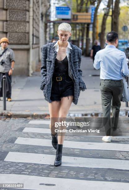 Guest wears grey jacket, denim shorts during the Womenswear Spring/Summer 2024 as part of Paris Fashion Week on September 28, 2023 in Paris, France.