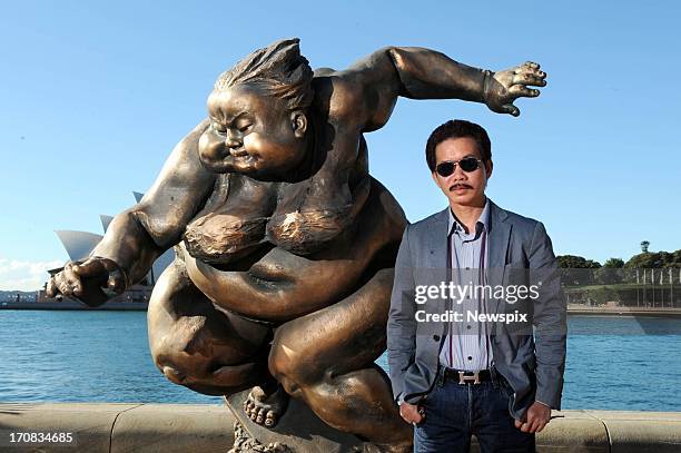 Artist Xu Hong Fei poses alongside his installations of his 'Chubby Womens Series' at Campbell's Cove, The Rocks on June 18, 2013 in Sydney,...