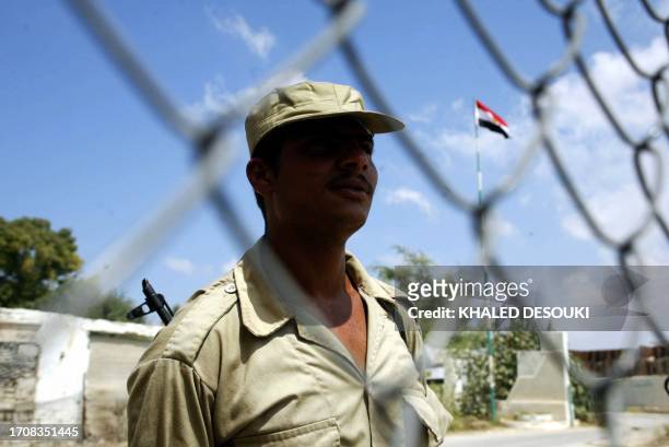 An Egyptian policeman stands guard on the borders between Egypt and Israel, at Salah el-Din Gate, in Egyptian Rafah, 11 September, 2005. As Israel...