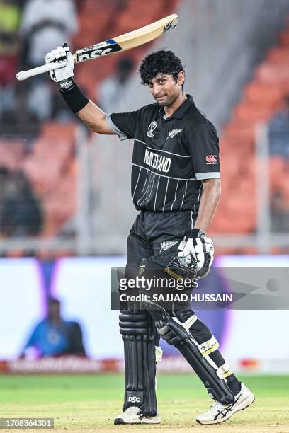 New Zealand's Rachin Ravindra celebrates after scoring a century during the 2023 ICC men's cricket World Cup one-day international match between...