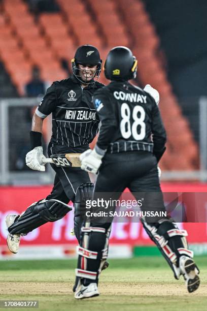 New Zealand's Rachin Ravindra and Devon Conway celebrate after winning the 2023 ICC men's cricket World Cup one-day international match between...