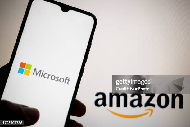 In this photo illustration a Microsoft logo seen displayed on a smartphone screen and Amazon logo in the background in Athens, Greece on October 5,...