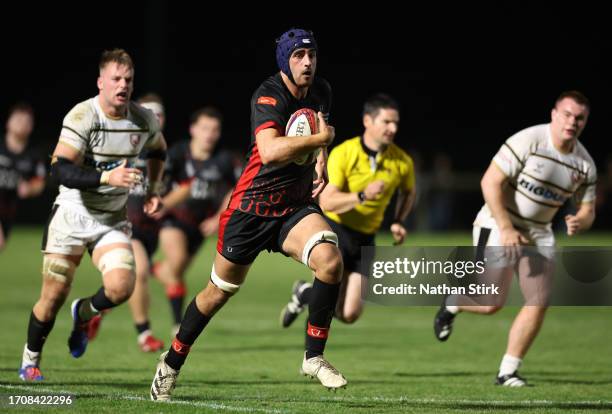 Sam Lewis of Hartpury breaks through the Gloucester defense during the Premiership Rugby Cup match between Hartpury University and Gloucester Rugby...