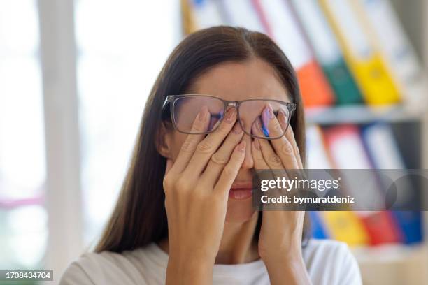 woman rubs her eyes after work - rubbing eyes stock pictures, royalty-free photos & images