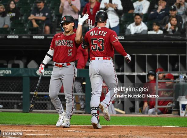 Christian Walker of the Arizona Diamondbacks is congratulated by Alek Thomas of the Arizona Diamondbacks following a home run against the Chicago...