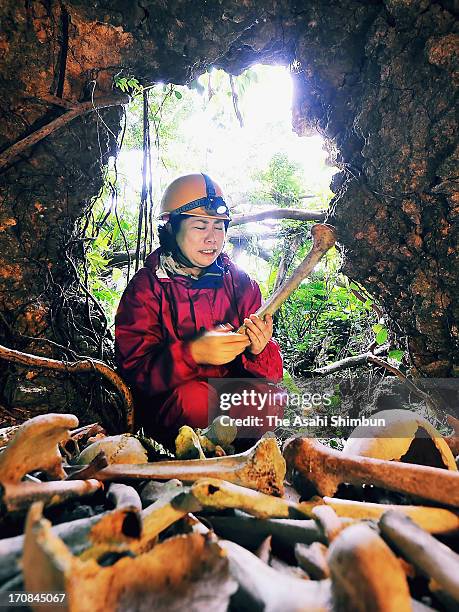 Maiko Masaki sheds tears as she found the remains of victims of the battle of Okinawa at a cave on February 5, 2013 in Itoman, Okinawa, Japan. During...