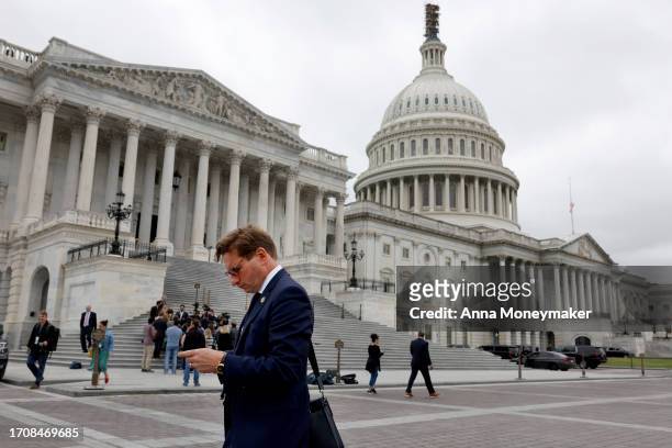 Rep. Dean Phillips looks at his phone as he leaves the U.S. Capitol Building on September 29, 2023 in Washington, DC. The House of Representatives...