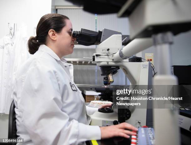 Houston Health Department Microbiologist Christina Utz demonstrates counting pollen and mold from the collection of spore sample Wednesday, March 15...