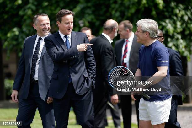 Prime Minister David Cameron gestures to the Speaker John Bercow at the LTA's #TennisIS event in the grounds of the Houses of Parliament on June 19,...