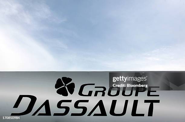 Logo sits above the Dassault Aviation SA's display booth on the second day of the Paris Air Show in Paris, France, on Tuesday, June 18, 2013. The...