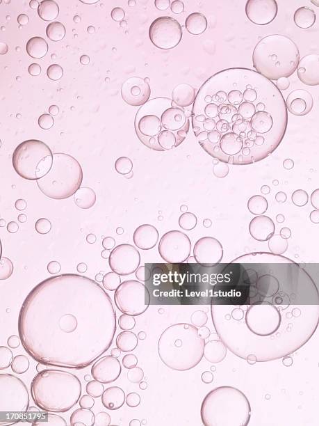 pink bubbles of oil and water - blase stock-fotos und bilder