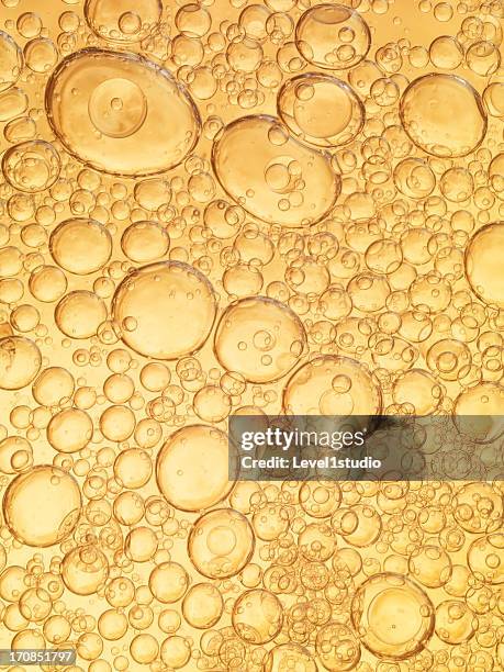 orange bubbles of oil and water - oil stock-fotos und bilder