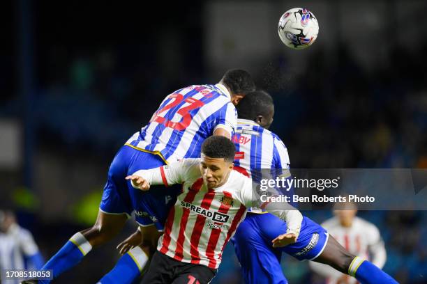 Bambo Diaby of Sheffield Wednesday and Akin Famewo of Sheffield Wednesday clash of heads during the Sky Bet Championship match between Sheffield...