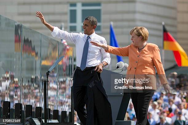 President Barack Obama and German Chancellor Angela Merkel wave as they leave the stage at the Brandenburg Gate on June 19, 2013 in Berlin, Germany....