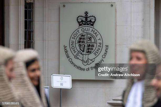 Female barristers, members of the Kings Counsel wearing black silk gowns and wigs stand outside The Supreme Court, the final court of appeal in the...