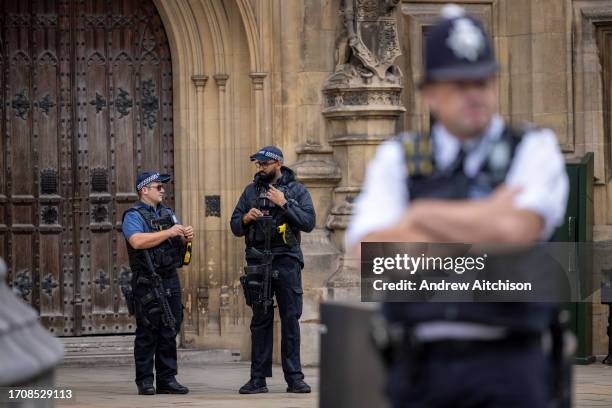 Two Armed Police officers carrying rifles and taser guns stand on duty outside The House of Commons during the Annual Judges Service on the 2nd of...