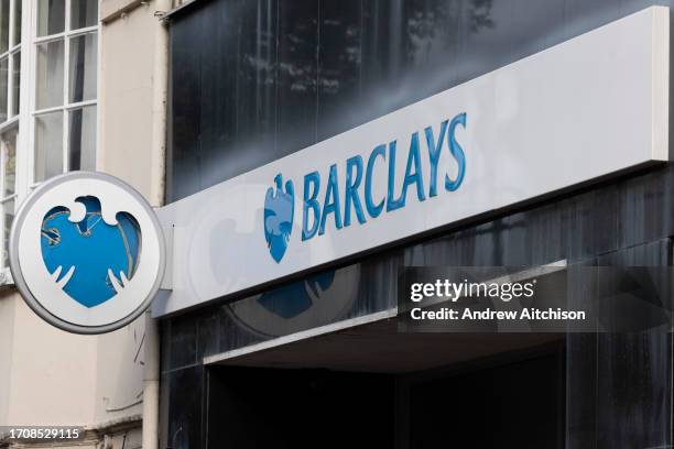 The Barclays Bank logo on the branch on 5th of October 2023 in Ashford, United Kingdom. Barclays Bank is a British multinational banking and...