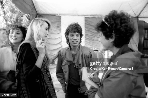 Mick Jagger of the Rolling Stones and Jerry Hall are photographed for the July 19, 1982 issue of People Magazine on June 25-26, 1982 backstage at...