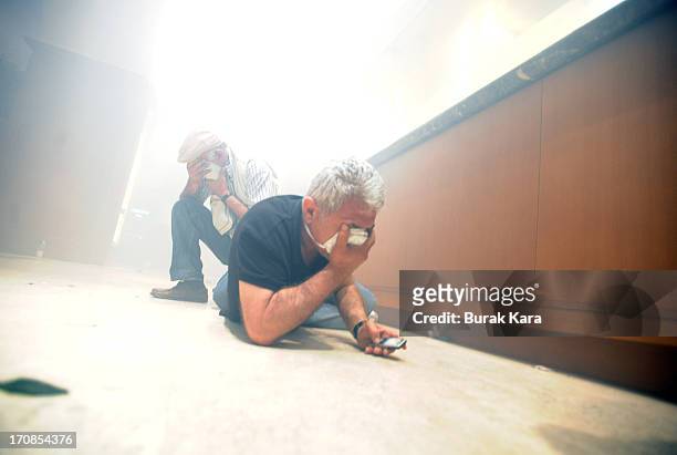 Protesters take shelter in the Divan Hotel during clashes with Turkish riot police firing tear gas on June 15, 2013 Istanbul, Turkey. Protests which...