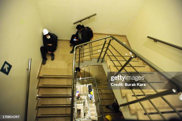 Protesters take shelter in the Divan Hotel during clashes with Turkish riot police firing tear gas on June 15, 2013 Istanbul, Turkey. Protests which...