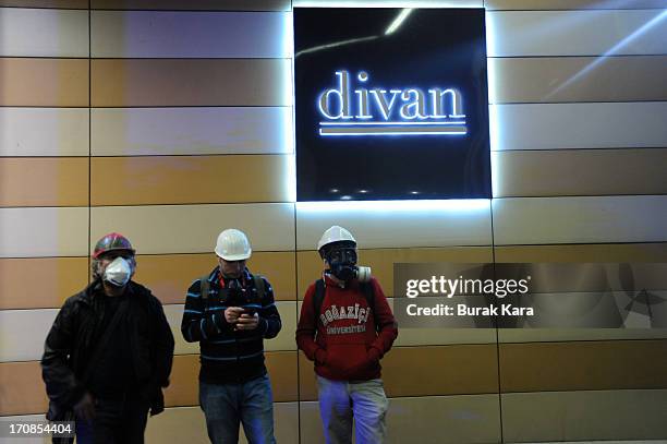 Protesters take shelter in the Divan Hotel during clashes with Turkish riot police firing tear gas on June 15, 2013 Istanbul, Turkey. Protests which...