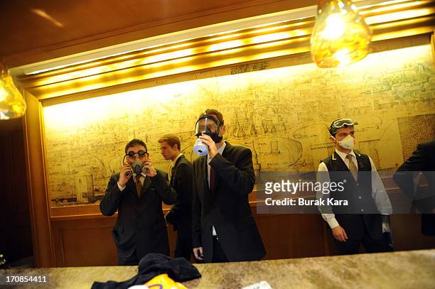 Protesters take shelter in the Divan Hotel during clashes with Turkish riot police firing tear gas on June 15, 2013 Istanbul, Turkey. Protests which...