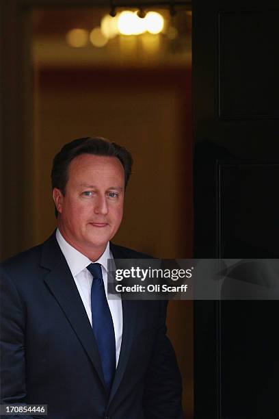 British Prime Minister David Cameron leaves Number 10 Downing Street to greet His Majesty King Abdullah II of Jordan on June 19, 2013 in London,...