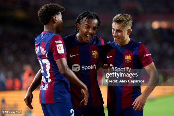 Lamine Yamal, Jules Kounde and Fermin Lopez of FC Barcelona celebrate after Sergio Ramos of Sevilla FC scored an own goal during the LaLiga EA Sports...