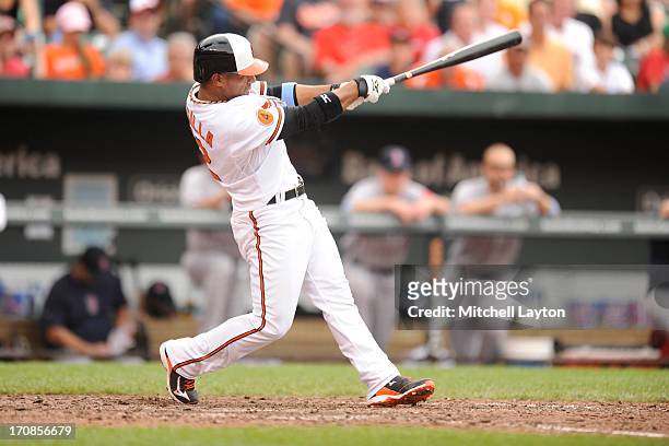 Alexi Casilla of the Baltimore Orioles takes a swing during a baseball game against the Boston Red Sox on June 16, 2013 at Oriole Park at Camden...