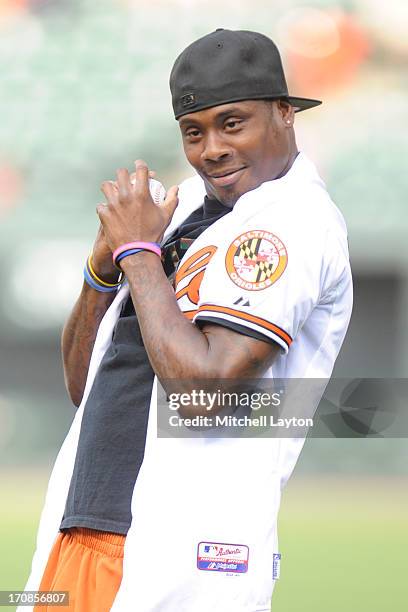 Baltimore Ravens football player Jacoby Jones throws out the first pitch before a baseball game between the Boston Red Sox and the Baltimore Orioles...