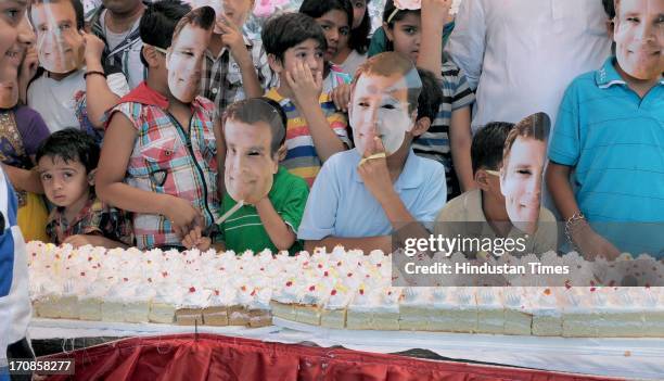 Children wearing mask of Congress Vice President Rahul Gandhi as they celebrate his 43rd birthday near the historical Hawa Mahal on June 19, 2013 in...