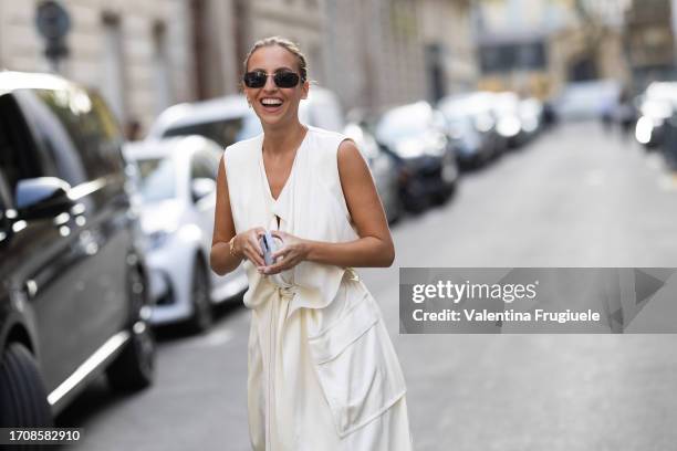 Guest is seen wearing black sunglasses and a white sleeveless white jacket outside the Victoria Beckham show during the Womenswear Spring/Summer 2024...