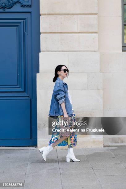 Guest is seen wearing a denim jacket, a large paillettes skirt and ankle boots outside Giambattista Valli show during the Womenswear Spring/Summer...