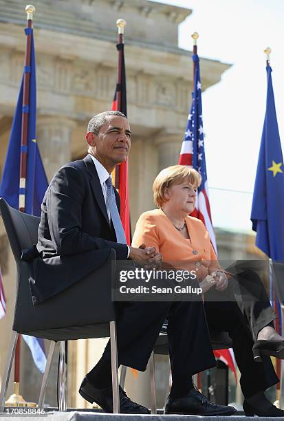 President Barack Obama and German Chancellor Angela Merkel arrive to speak at the Brandenburg Gate on June 19, 2013 in Berlin, Germany. Obama is...