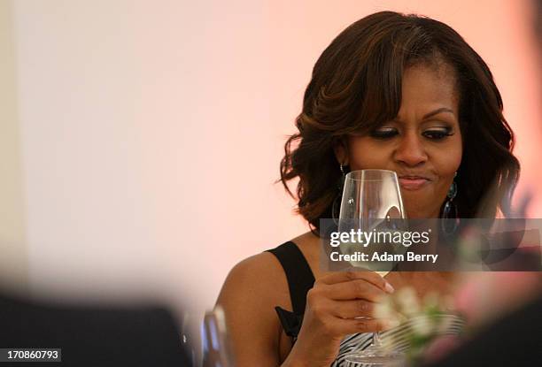 First Lady Michelle Obama tries her wine during a dinner at the Orangerie at Schloss Charlottenburg palace on June 19, 2013 in Berlin, Germany. Obama...