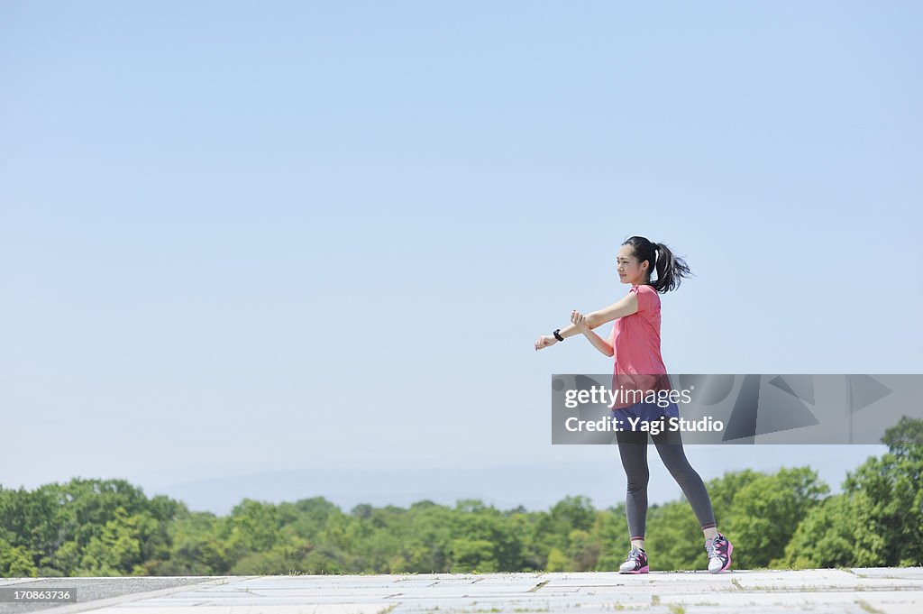 Woman having a warm-up for a run.