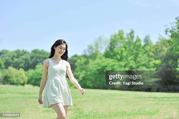 woman walking in nature - sunny days stock-fotos und bilder