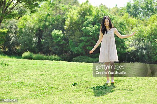 woman enjoying in nature - long green dress stock pictures, royalty-free photos & images