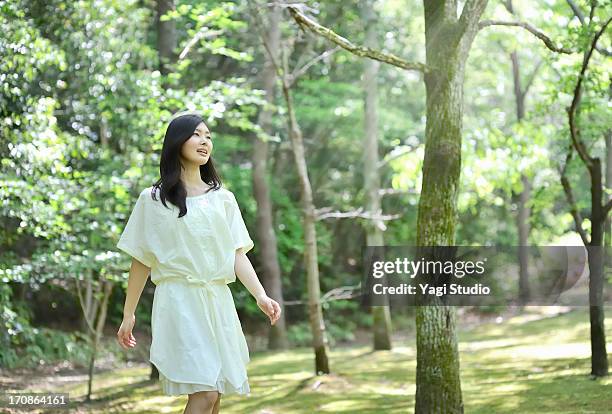 woman walking in nature - women white dress stock pictures, royalty-free photos & images